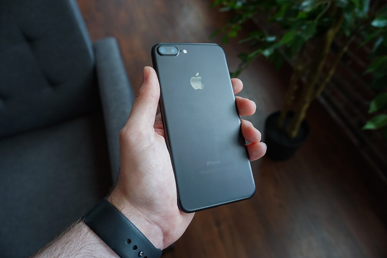 A person holding a black smartphone in one hand, representing the iPhone 18 launch season that usually arrives in September