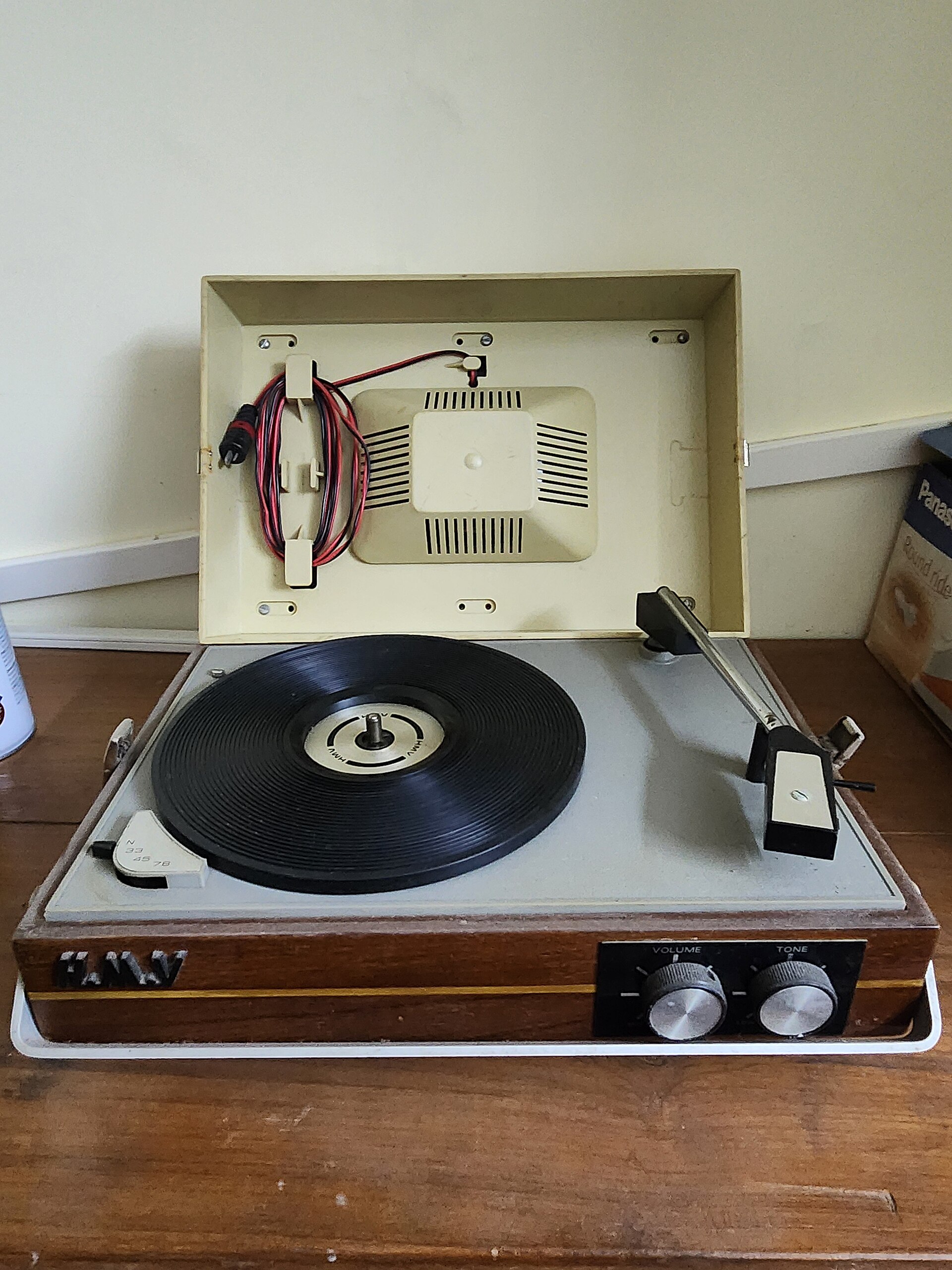 A portable vintage record player in a wooden case