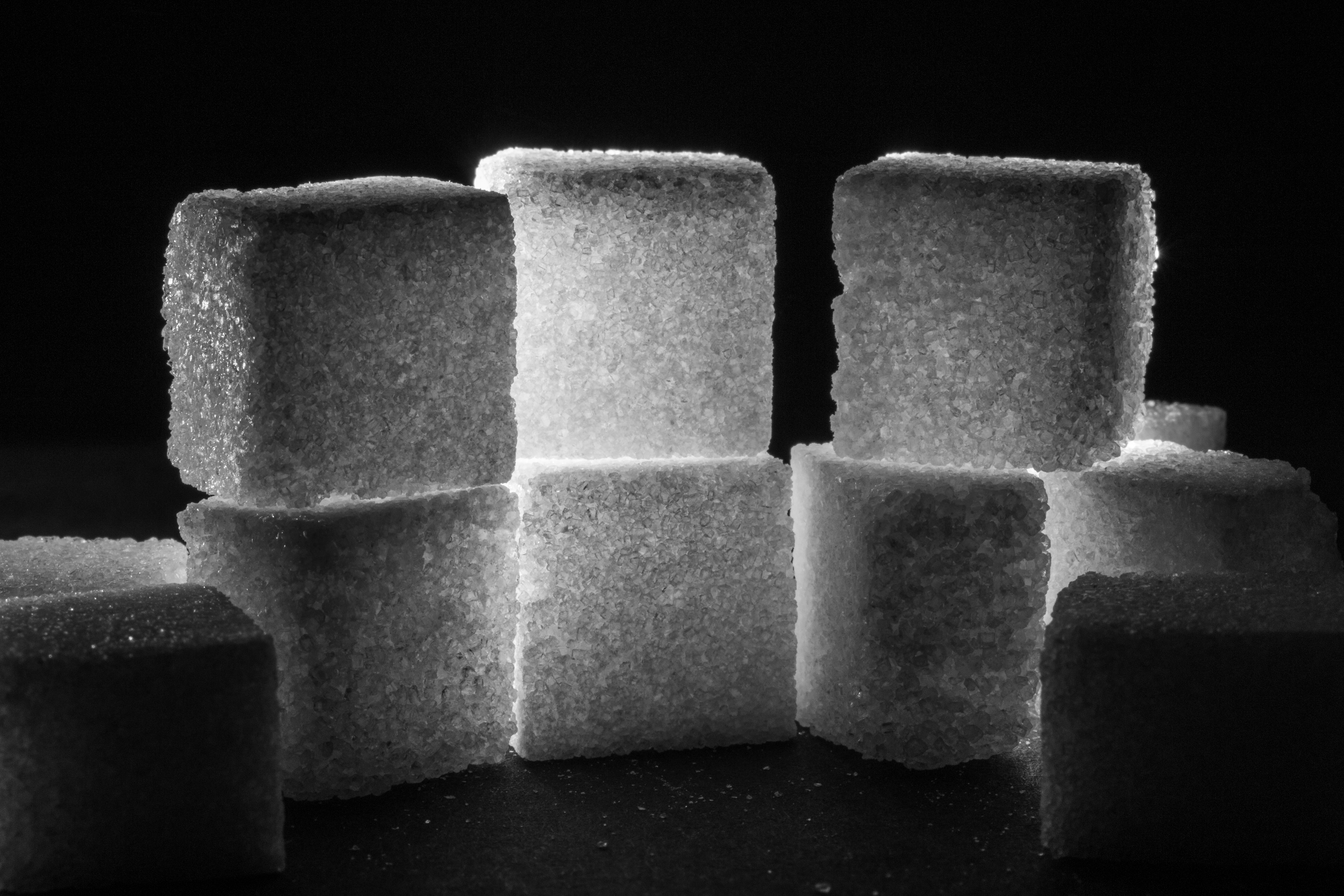 White sugar cubes spilling across a surface